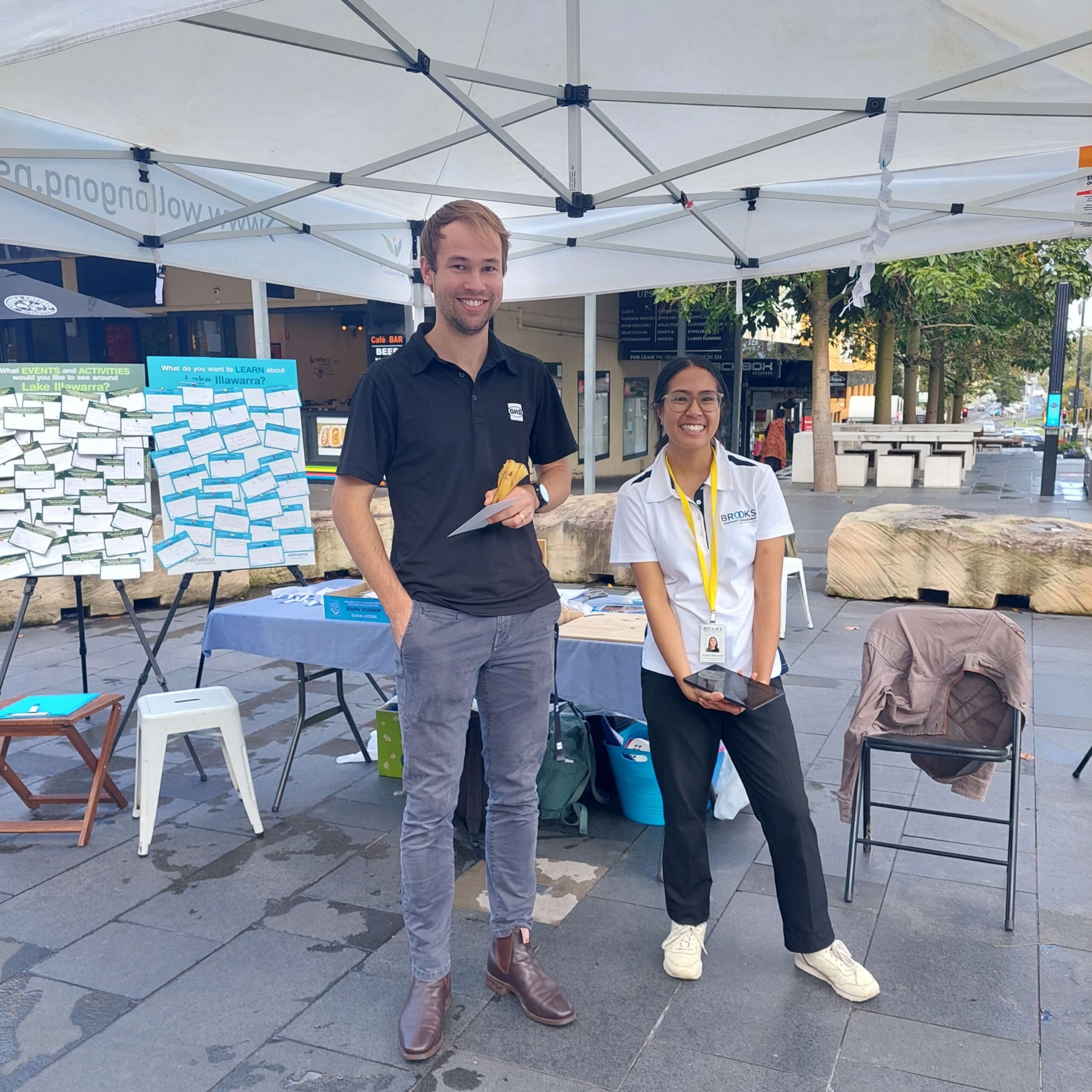 Community Engagement Officer at Wollongong Central Mall inviting the public to respond to the questions posed on the Ideas Wall.